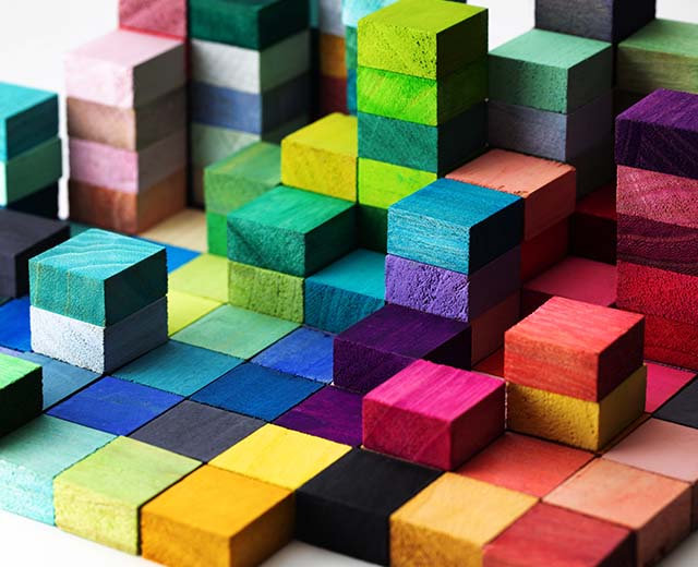 Colorful wooden blocks stacked in different heights.