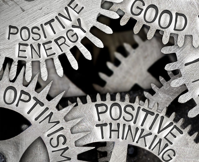 Gears with words on them including "positive energy" and "positive thinking."