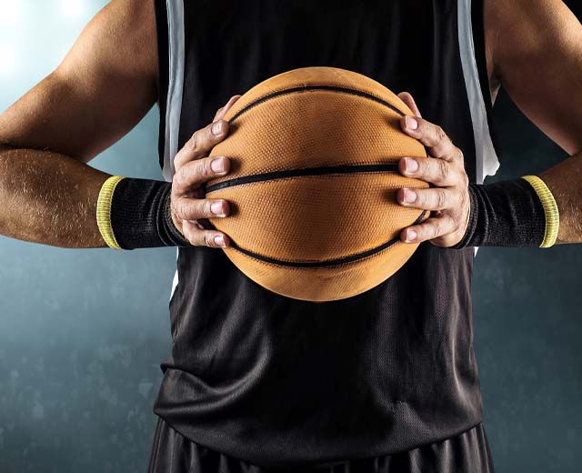 A basketball player holding a basketball.