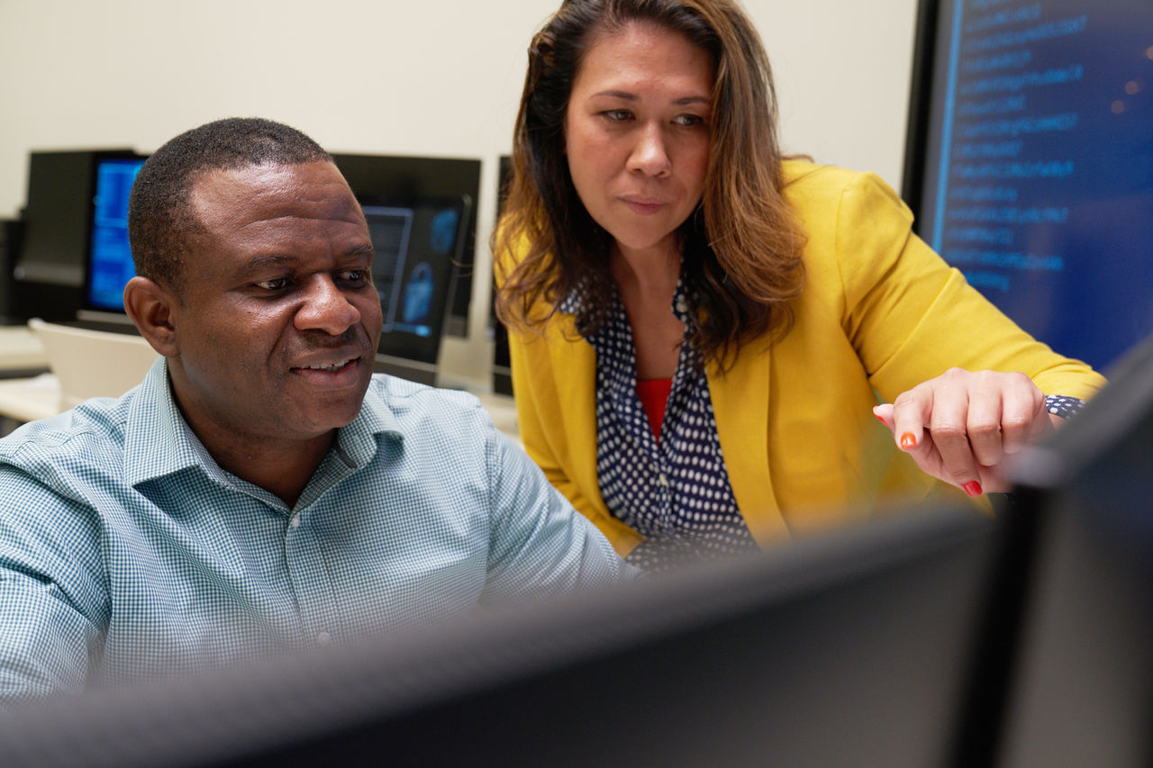 Man and woman looking at computer. 