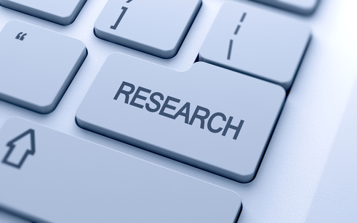 Research word button on keyboard with soft focus