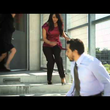 Three people running down a set of stairs.