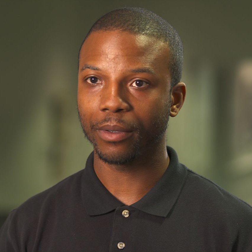 A UMGC master's student looking at the camera during an interview.