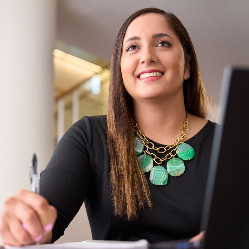 A person taking notes and smiling.