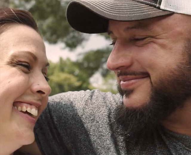 Two people smiling at eachother. 