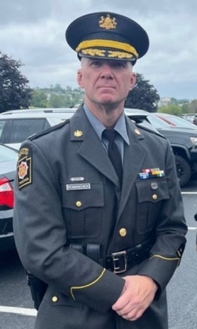 Pennsylvania State Police Captain Jessie Romanchick and a map of Pennsylvania