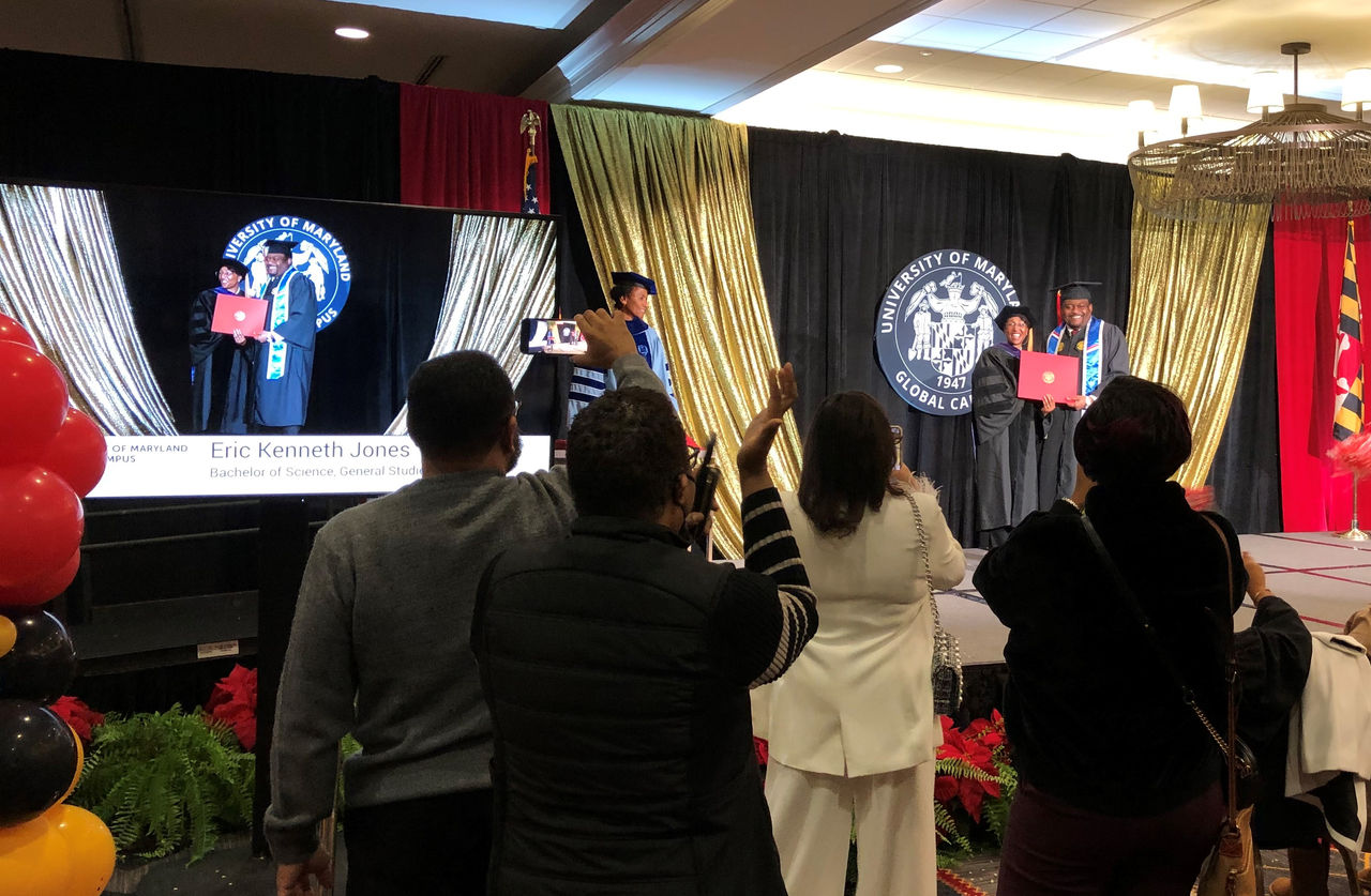 Graduates receive their diploma with family and friends up close to celebrate the accomplishment.