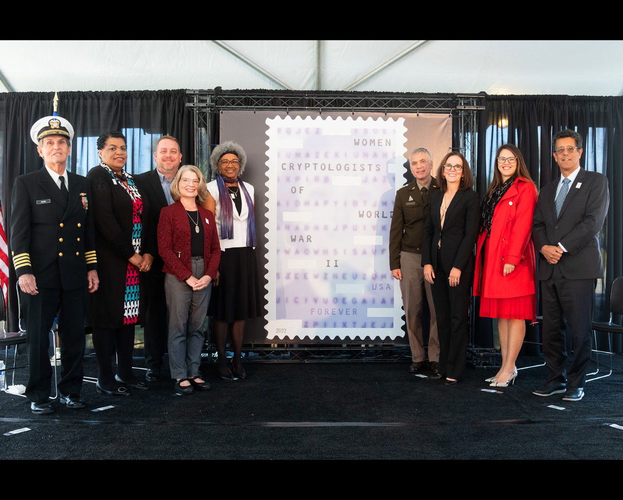 ANNAPOLIS JUNCTION, MD — The U.S. Postal Service honored the work of the Women Cryptologists of World War II with a first-day-of-issue ceremony for the Forever stamp at the National Cryptologic Museum. 
“During World War II, some 11,000 women labored day and night, helping to process and decipher an endless stream of enemy military messages,” said Jakki Krage Strako, the Postal Service’s chief commerce and business solutions officer, who served as the dedicating official for the stamp event. 
“Their work was both frustrating and exhilarating (sometimes simultaneously) —and one of the conflict’s best-kept secrets,” she said. “With this stamp, the U.S. Postal Service honors all of the women cryptologists of World War II, whose service played an inestimable role in the Allied victory.”
The surprise attack on Pearl Harbor made it clear that an enormous and immediate increase in the number of cryptologists was essential. With young men enlisting to serve overseas and more needed every day, the armed forces looked to women. Many women cryptologists were civilians recruited while still in college or working as schoolteachers. By the end of the war, women cryptologists numbered around 7,000 in the Army and about 4,000 in the Navy — more than half of all U.S. cryptologists.
Their service played a significant role in the Allied victory. Women cryptologists deciphered Japanese fleet communications, helped prevent German U-boats from sinking vital cargo ships, and worked to break the encryption systems that revealed Japanese shipping routes and diplomatic messages. They built high-speed machines to break encrypted German messages, intercepted enemy communications, and ensured that encrypted U.S. messages were secure and error-free — an early form of cybersecurity.
Sworn to secrecy — under penalty of treason — the women cryptologists of World War II remained silent about their crucial and far-reaching contributions for decades. Today, they are widely 