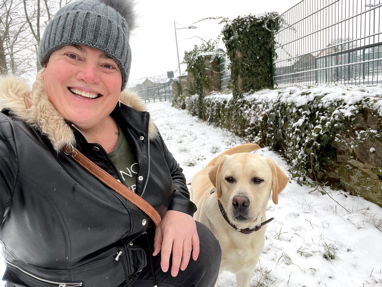 Gina Winters with her service dog Irma. Irma helps Winters manage migraines, traumatic brain injury, mobility, and equilibrium issues following injuries suffered during her military career, including from a helicopter crash in Gaum.