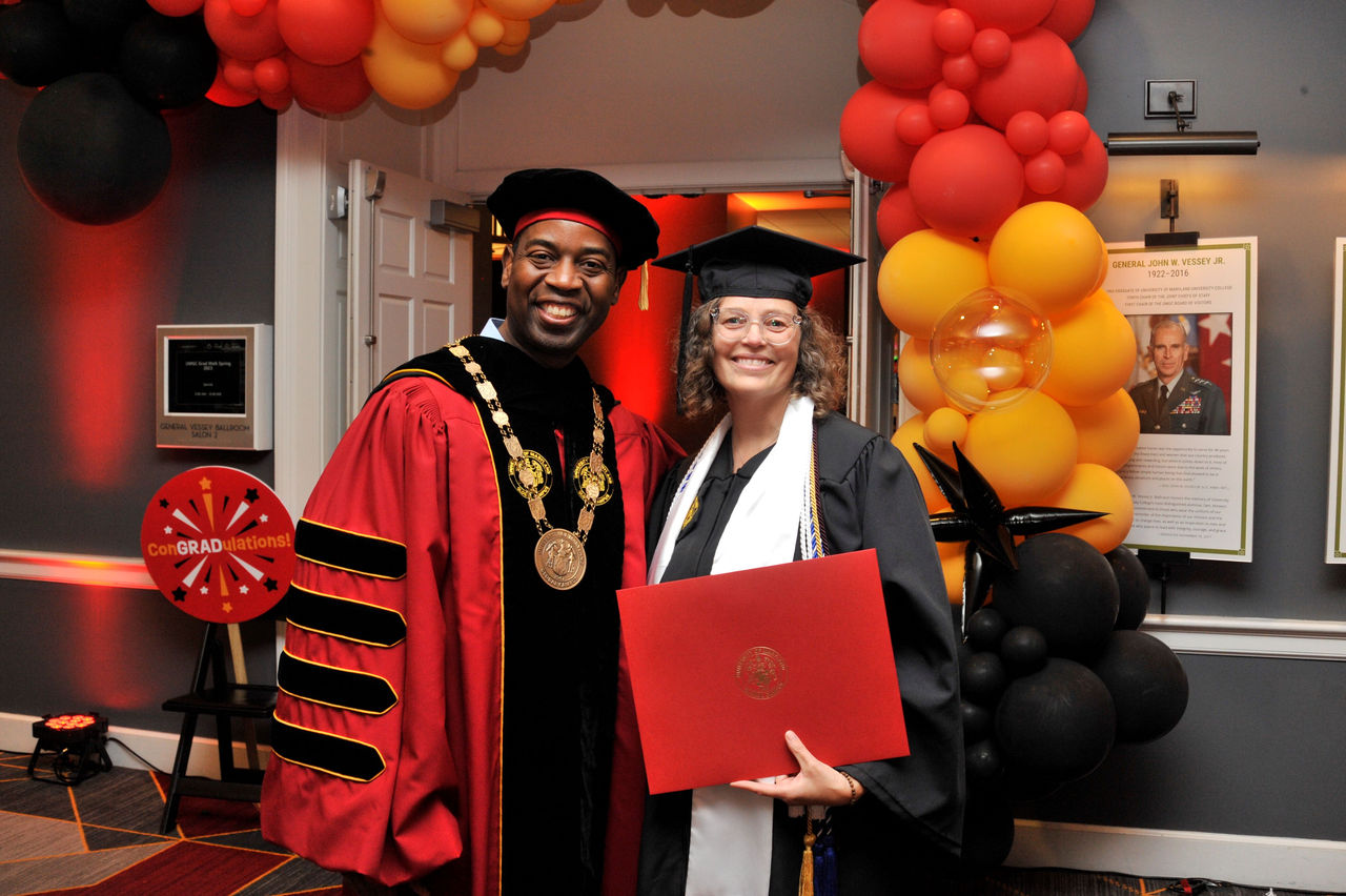 UMGC President Gregory Fowler celebrates with Vanessa Engelhardt, a recipient of a Pillars of Strength Scholarship, which honors the volunteer caregivers of injured and wounded servicemembers.