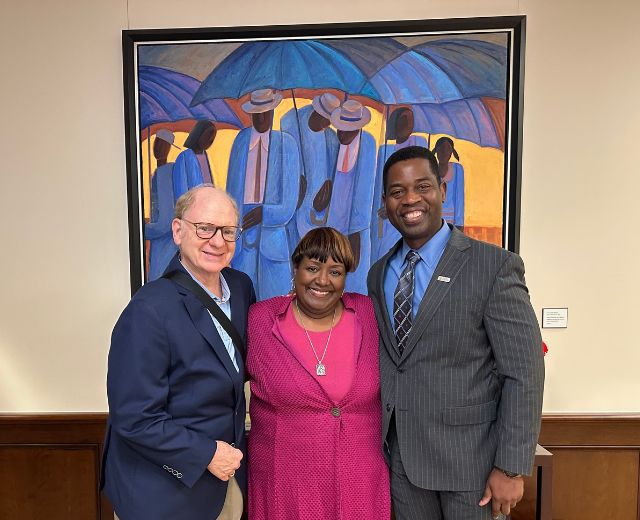 Clarissa Peterson with her husband Edward Archer (left) and UMGC President Gregory Fowler.