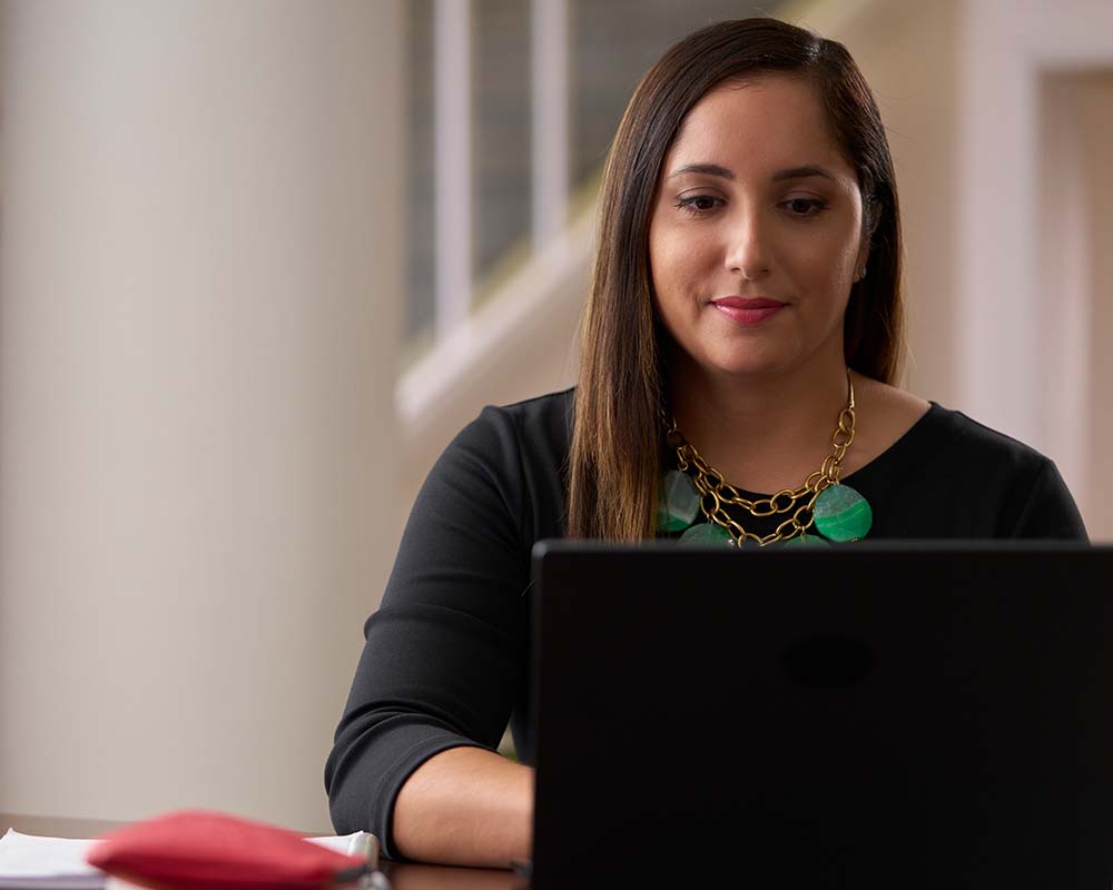 A person typing on a laptop.