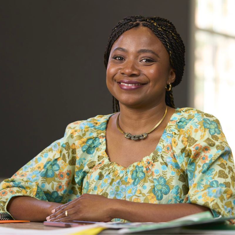 A person sitting and smiling.