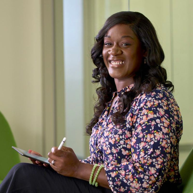 A person taking notes and smiling.