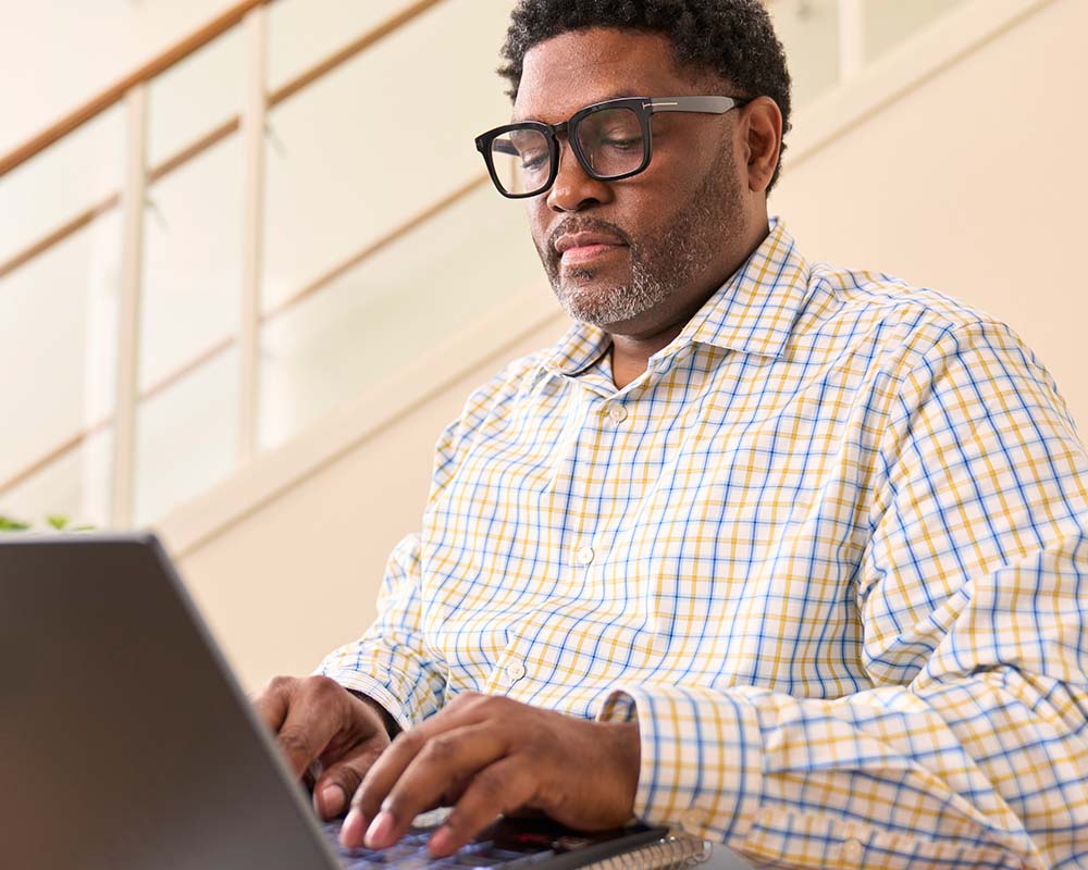 A person typing on a laptop.