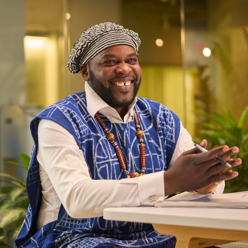 A person sitting and smiling.