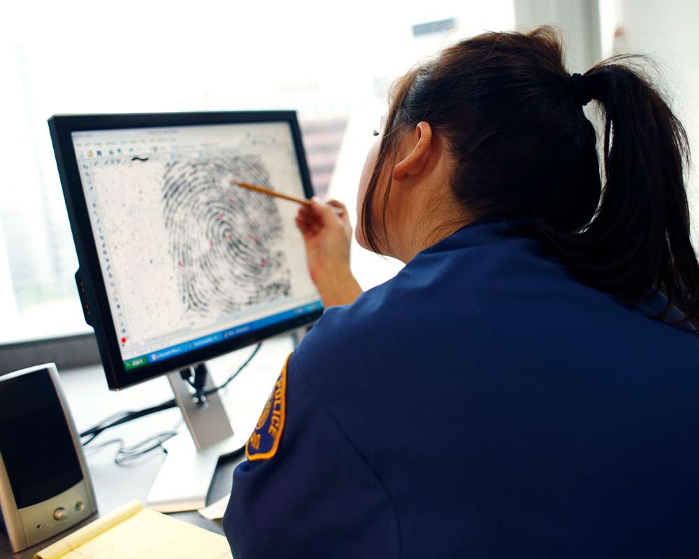 A person is looking at a closeup of a fingerprint on their computer.