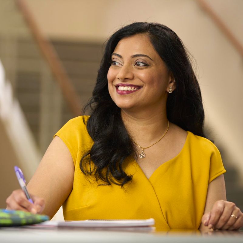 A person taking notes and smiling.