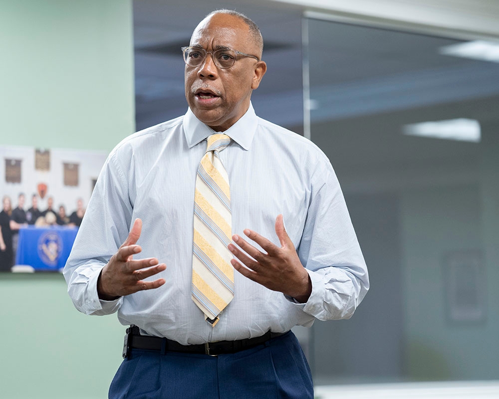 A UMGC criminal justice faculty member speaking while in business attire. 