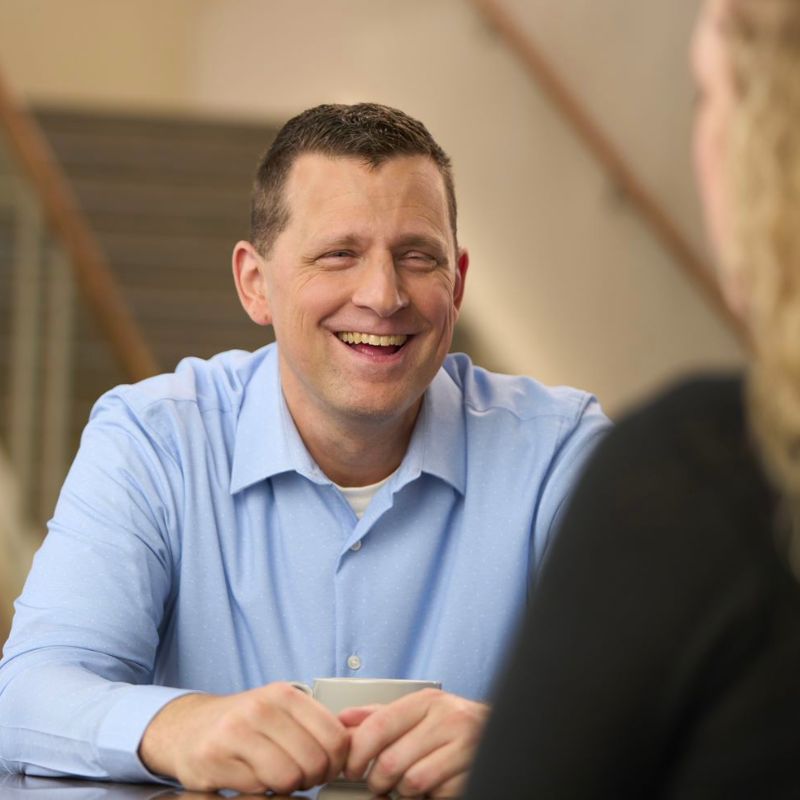 A person talking and smiling inside.