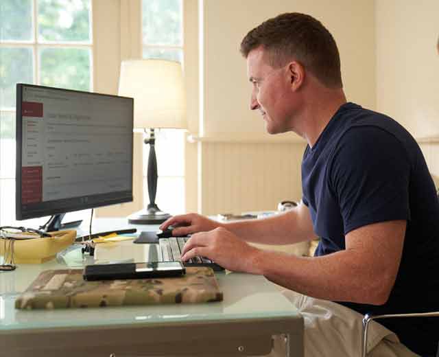 A person looking at a computer monitor.